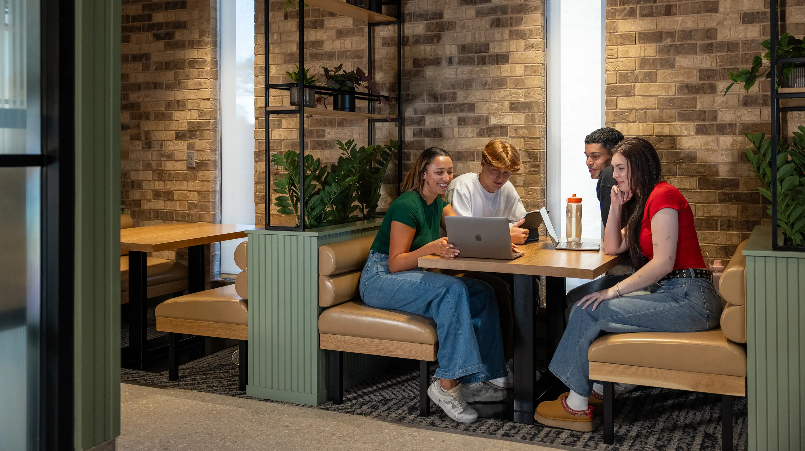 a group of friends studying in a booth