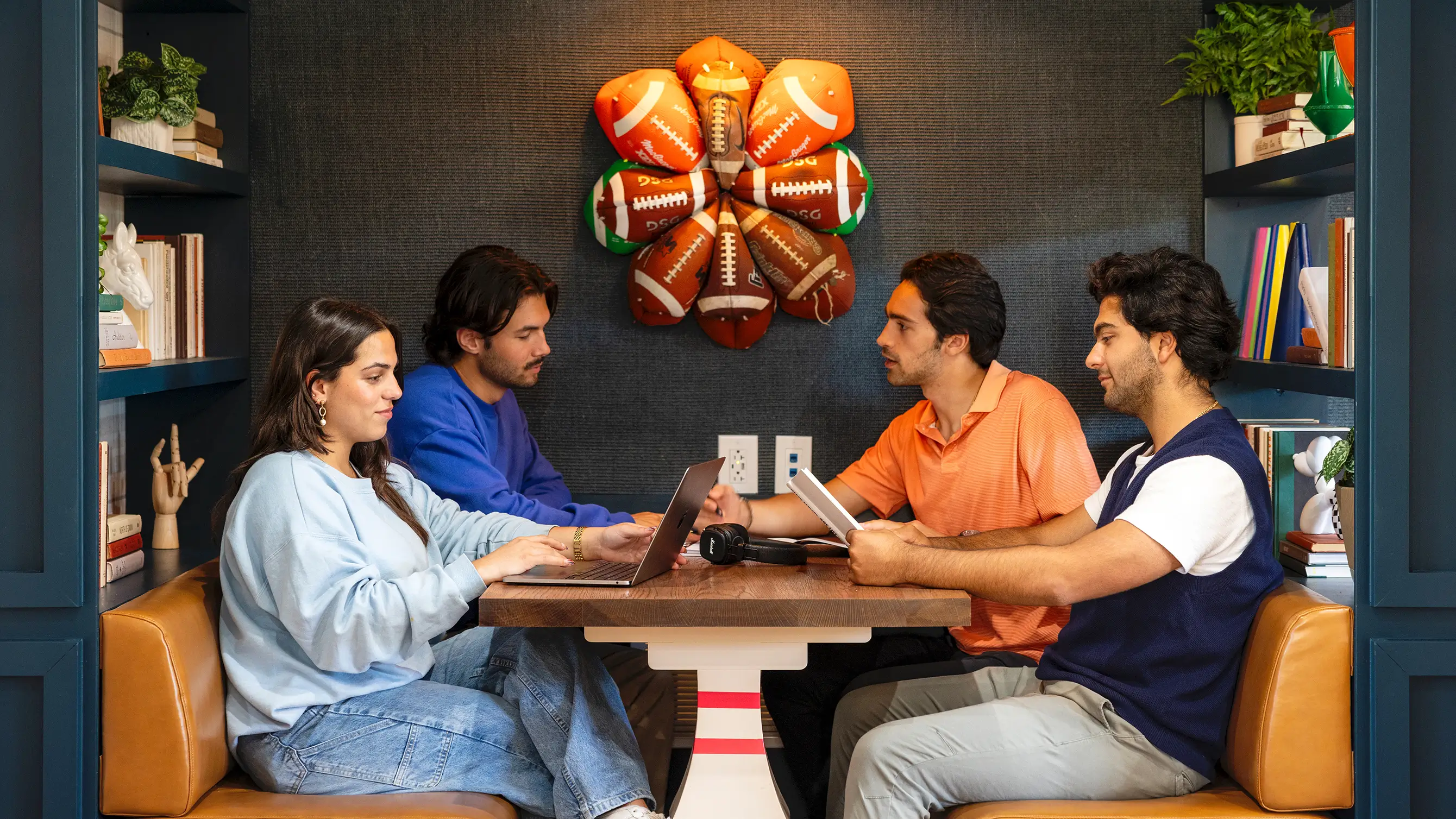 a group of friends studying using laptops